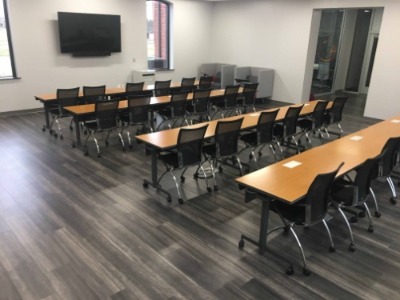Highway 44 digital library with long tables and chairs facing a television